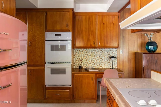 85 Gardenia Ct, Upland, CA 91786 - kitchen featuring white appliances, tile countertops, decorative backsplash, brown cabinets, and premium range hood