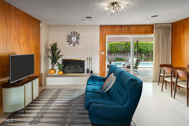 85 Gardenia Ct, Upland, CA 91786 - living room featuring wood walls, a brick fireplace, a textured ceiling, and brick wall