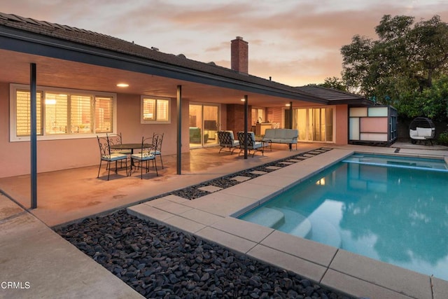 85 Gardenia Ct, Upland, CA 91786 - pool at dusk with an outdoor hangout area, a patio area, and an outdoor pool