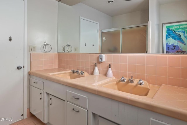 85 Gardenia Ct, Upland, CA 91786 - bathroom featuring double vanity, tasteful backsplash, an enclosed shower, and tile patterned floors