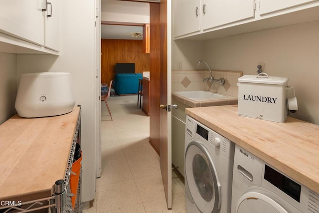 85 Gardenia Ct, Upland, CA 91786 - laundry room with cabinet space, washing machine and clothes dryer, light floors, and wooden walls