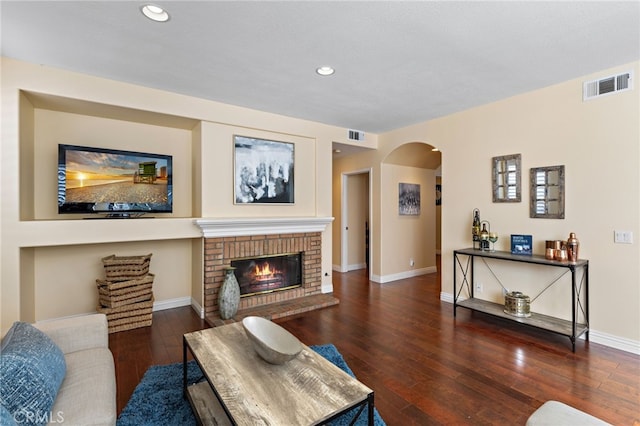 2811 N Preston St, Orange, CA 92867 - living room featuring arched walkways, hardwood / wood-style flooring, baseboards, a brick fireplace, and recessed lighting