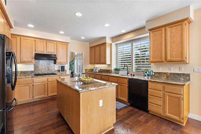 2811 N Preston St, Orange, CA 92867 - kitchen with black appliances, dark wood-style floors, under cabinet range hood, a kitchen island, and stone countertops
