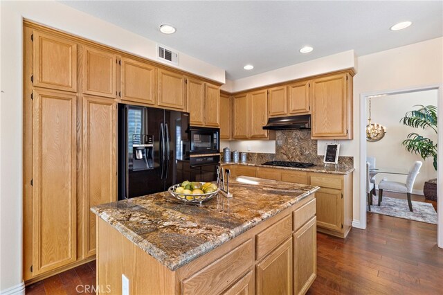 2811 N Preston St, Orange, CA 92867 - kitchen featuring black appliances, under cabinet range hood, stone countertops, dark wood finished floors, and tasteful backsplash