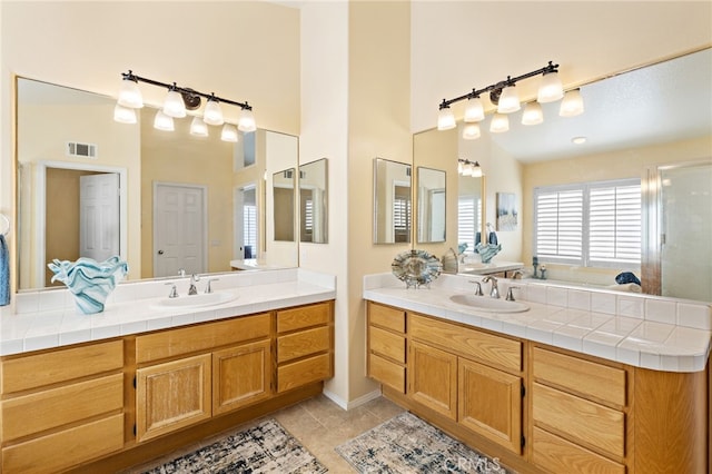 2811 N Preston St, Orange, CA 92867 - bathroom featuring vanity, tile patterned floors, a towering ceiling, and a shower with door