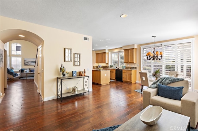 2811 N Preston St, Orange, CA 92867 - living area featuring arched walkways, dark wood finished floors, a chandelier, plenty of natural light, and recessed lighting