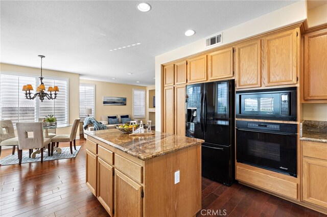 2811 N Preston St, Orange, CA 92867 - kitchen featuring black appliances, dark wood-style floors, a center island, a chandelier, and light stone countertops