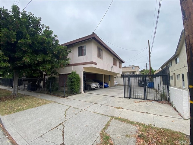 1667 W 208th St, Torrance, CA 90501 - view of home's exterior featuring stucco siding, a gate, and covered parking