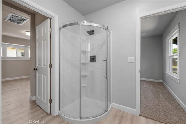 1906 N Fruit Ave, Fresno, CA 93705 - full bath featuring a shower stall, wood finished floors, plenty of natural light, and baseboards
