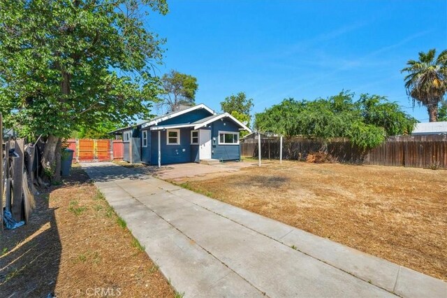 1906 N Fruit Ave, Fresno, CA 93705 - view of front of home featuring concrete driveway and a fenced backyard