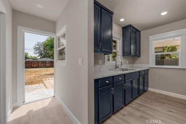 1906 N Fruit Ave, Fresno, CA 93705 - kitchen with a sink, healthy amount of natural light, light wood-type flooring, baseboards, and recessed lighting