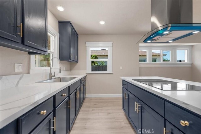 1906 N Fruit Ave, Fresno, CA 93705 - kitchen with a sink, wall chimney range hood, baseboards, light wood-style floors, and black electric cooktop