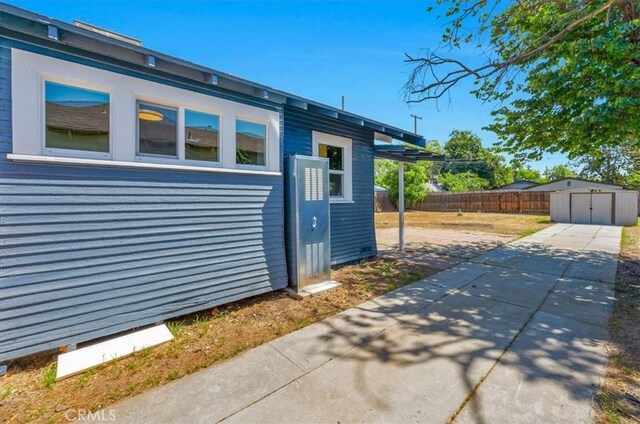 1906 N Fruit Ave, Fresno, CA 93705 - view of side of home featuring a fenced backyard and a patio area