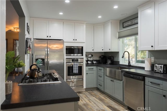 1315 Sequoia Dr, Lake Arrowhead, CA 92352 - kitchen featuring stainless steel appliances, dark countertops, a warming drawer, recessed lighting, and light wood-style floors