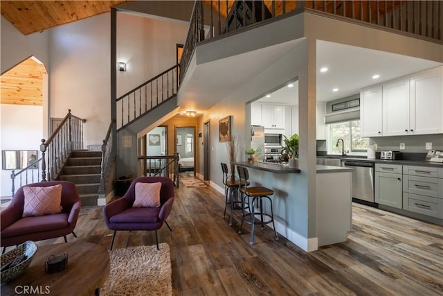1315 Sequoia Dr, Lake Arrowhead, CA 92352 - living area featuring dark wood finished floors, stairs, a high ceiling, and recessed lighting