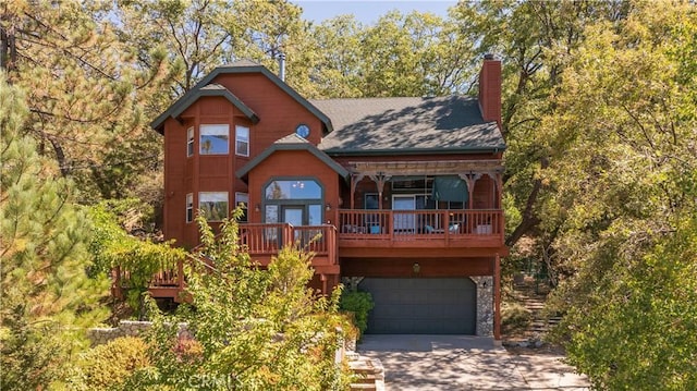 1315 Sequoia Dr, Lake Arrowhead, CA 92352 - view of front facade with driveway, an attached garage, a chimney, and roof with shingles