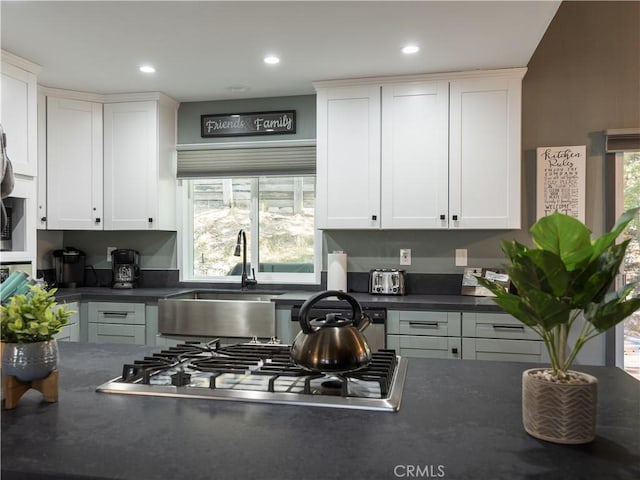 1315 Sequoia Dr, Lake Arrowhead, CA 92352 - kitchen with stainless steel gas stovetop, dark countertops, a sink, white cabinets, and recessed lighting