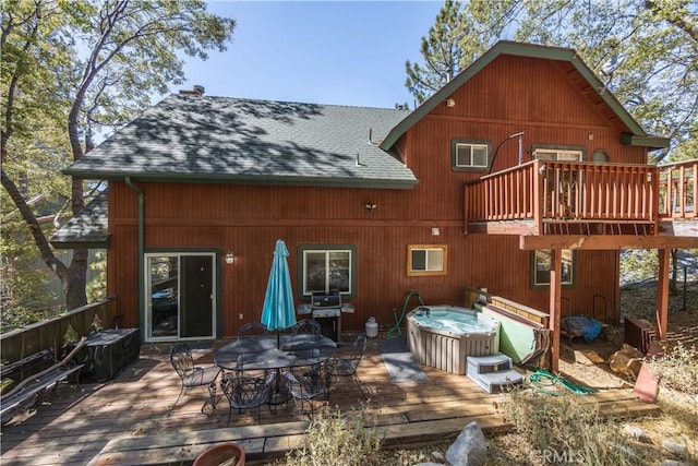 1315 Sequoia Dr, Lake Arrowhead, CA 92352 - back of house with a hot tub, roof with shingles, a deck, and outdoor dining space
