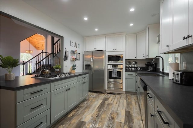 1315 Sequoia Dr, Lake Arrowhead, CA 92352 - kitchen with stainless steel appliances, dark countertops, a warming drawer, wood finished floors, and recessed lighting