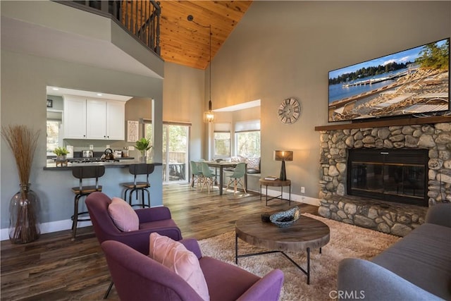 1315 Sequoia Dr, Lake Arrowhead, CA 92352 - living area featuring baseboards, dark wood-style floors, high vaulted ceiling, wooden ceiling, and a stone fireplace