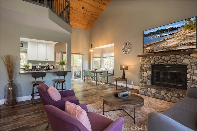 1315 Sequoia Dr, Lake Arrowhead, CA 92352 - living room with dark wood finished floors, high vaulted ceiling, wood ceiling, and a stone fireplace
