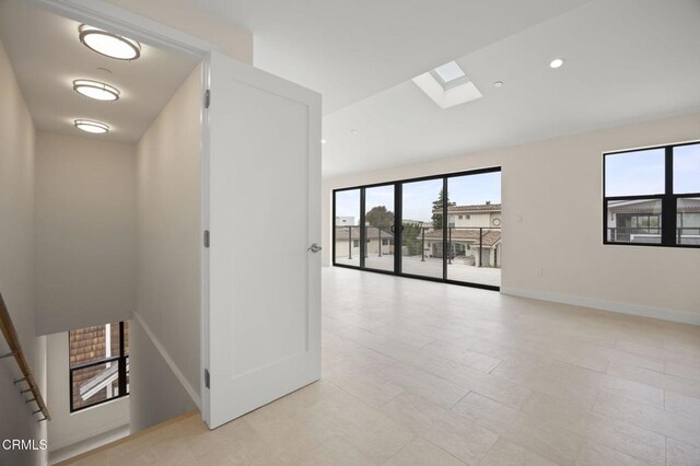 1194 Kingston Ln, Ventura, CA 93001 - spare room with a skylight, lofted ceiling, and baseboards