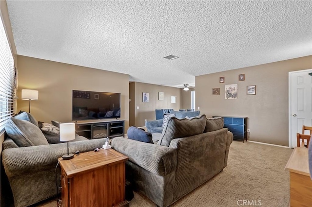 8600 San Vicente Dr, Yucca Valley, CA 92284 - living area with a textured ceiling, ceiling fan, light colored carpet, and baseboards
