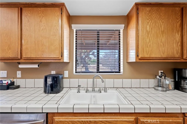 8600 San Vicente Dr, Yucca Valley, CA 92284 - kitchen with a sink, dishwasher, and brown cabinetry