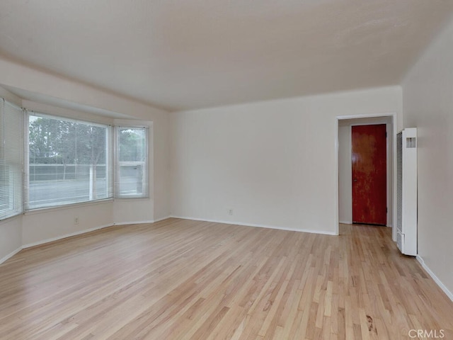 4265 Crescent Ave, Cypress, CA 90630 - spare room featuring a heating unit, light wood-style floors, and baseboards