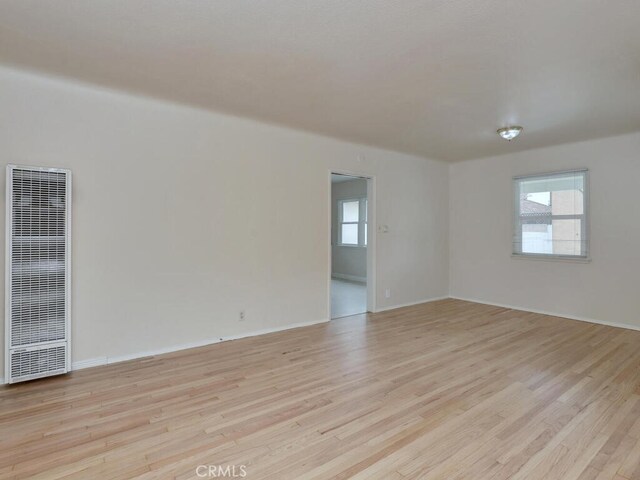 4265 Crescent Ave, Cypress, CA 90630 - unfurnished room featuring a heating unit, light wood finished floors, and baseboards