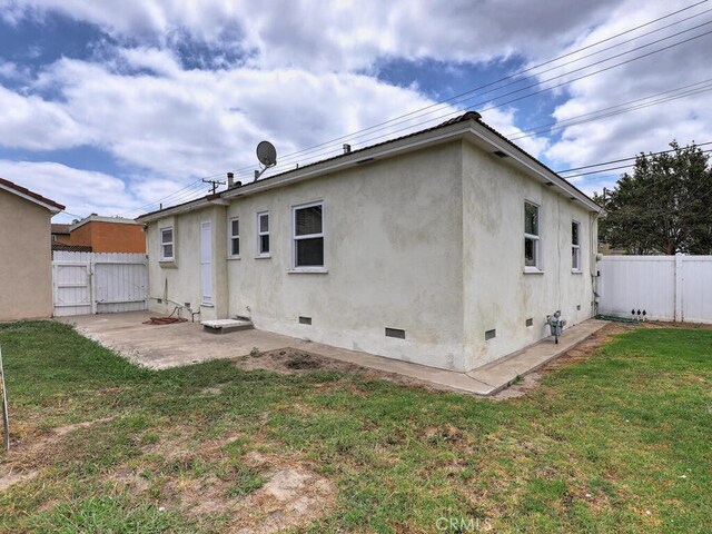 4265 Crescent Ave, Cypress, CA 90630 - rear view of house with crawl space, stucco siding, and a patio