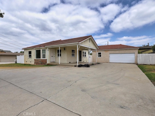 4265 Crescent Ave, Cypress, CA 90630 - single story home with stucco siding, covered porch, driveway, a tiled roof, and a garage
