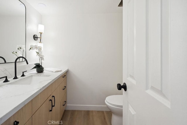 6101 Fulton Ave Unit 8, Van Nuys, CA 91401 - bathroom with vanity, wood finished floors, toilet, and baseboards