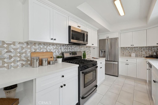 6101 Fulton Ave Unit 8, Van Nuys, CA 91401 - kitchen featuring stainless steel appliances, white cabinets, backsplash, light countertops, and a raised ceiling