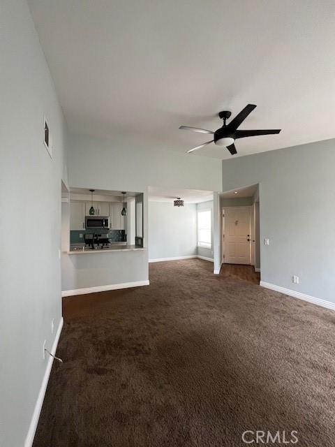 2015 Lakeridge Cir Unit 301, Chula Vista, CA 91913 - unfurnished living room featuring a ceiling fan, carpet flooring, and baseboards