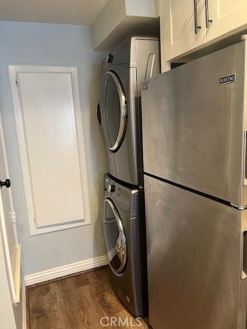 2015 Lakeridge Cir Unit 301, Chula Vista, CA 91913 - washroom featuring cabinet space, wood finished floors, stacked washing machine and dryer, and baseboards