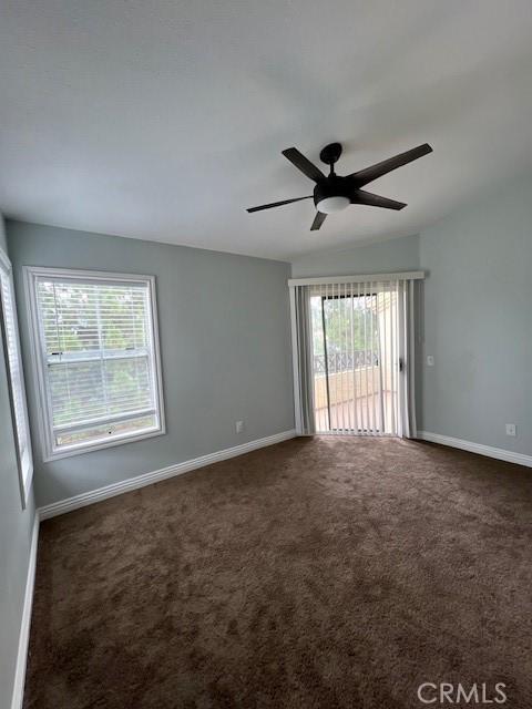 2015 Lakeridge Cir Unit 301, Chula Vista, CA 91913 - empty room with dark carpet, baseboards, and a ceiling fan