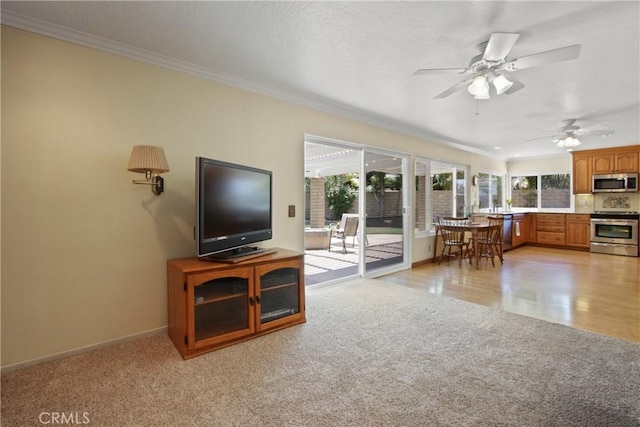 20392 Densmore Ln, Huntington Beach, CA 92646 - living area featuring light colored carpet, crown molding, and a ceiling fan