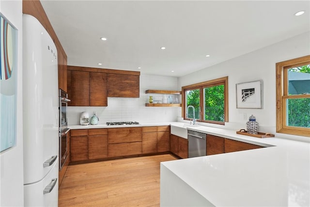 116 E Yale Loop Unit 9, Irvine, CA 92604 - kitchen featuring dishwasher, healthy amount of natural light, brown cabinets, light wood-style flooring, and recessed lighting