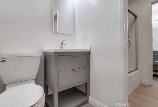 18417 Santar St, Rowland Heights, CA 91748 - full bathroom featuring vanity, toilet, wood finished floors, baseboards, and bath / shower combo with glass door