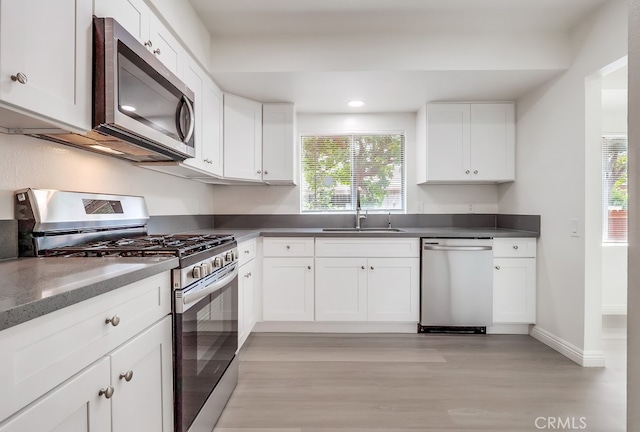 18417 Santar St, Rowland Heights, CA 91748 - kitchen featuring stainless steel appliances, a sink, light wood-style flooring, healthy amount of natural light, and recessed lighting