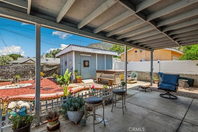 33206 Churchill St, Lake Elsinore, CA 92530 - fenced backyard featuring a hot tub, a patio, and an outdoor structure
