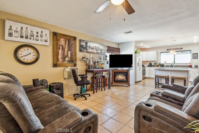 33206 Churchill St, Lake Elsinore, CA 92530 - living room with a ceiling fan, light tile patterned floors, an AC wall unit, and a textured ceiling