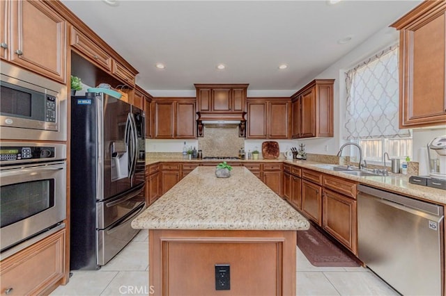 1330 W Marigold Ave, La Habra, CA 90631 - kitchen featuring stainless steel appliances, a sink, light tile patterned floors, a center island, and light stone counters