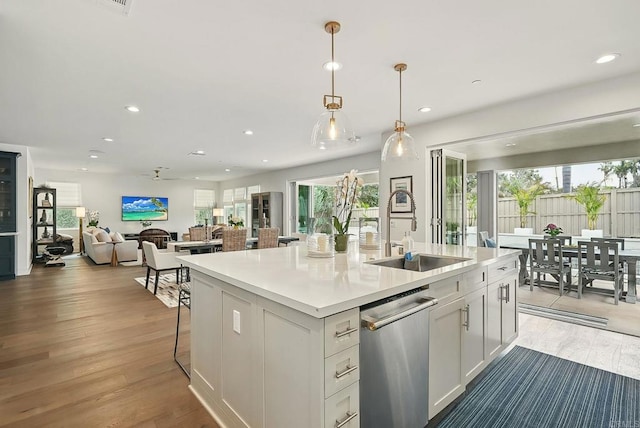 939 Moonstone Ct, Encinitas, CA 92024 - kitchen with a sink, stainless steel dishwasher, recessed lighting, open floor plan, and wood finished floors