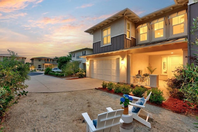 939 Moonstone Ct, Encinitas, CA 92024 - view of front of home featuring board and batten siding, concrete driveway, a garage, and stucco siding