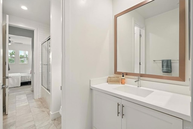 939 Moonstone Ct, Encinitas, CA 92024 - ensuite bathroom featuring vanity, marble finish floors, bath / shower combo with glass door, recessed lighting, and ceiling fan