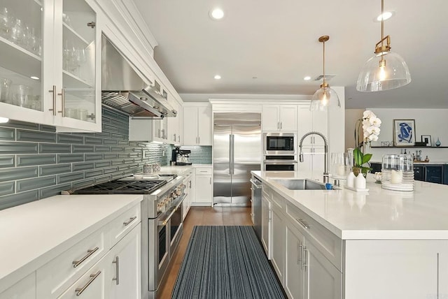 939 Moonstone Ct, Encinitas, CA 92024 - kitchen featuring built in appliances, a sink, wall chimney exhaust hood, light countertops, and recessed lighting