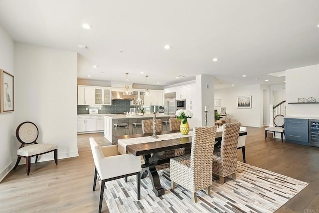 939 Moonstone Ct, Encinitas, CA 92024 - dining space featuring light wood finished floors, recessed lighting, baseboards, and wine cooler