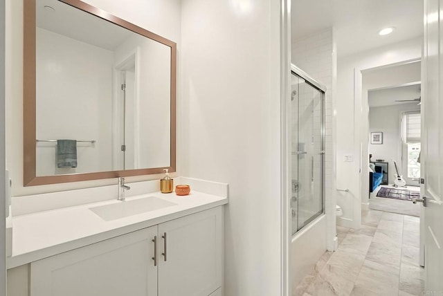 939 Moonstone Ct, Encinitas, CA 92024 - ensuite bathroom featuring marble look tiles, vanity, enclosed tub / shower combo, baseboards, and recessed lighting